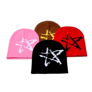 Winter knitted beanie hats with star jacquard patterns in multiple colors on white background