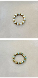 Detail view of elastic beaded rings with natural turquoise and golden stainless steel beads