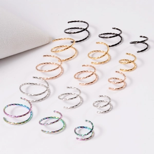 Detail of twisted double spiral nose rings in various sizes and five metallic finishes
