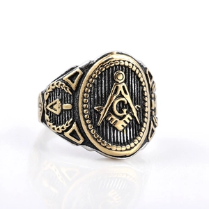Vintage stainless steel Freemasonry G ring with tricolor finish on white background