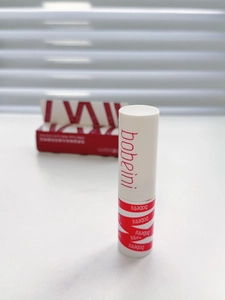 Macro shot of matte velvet lip mud with white tube design and red logo packaging