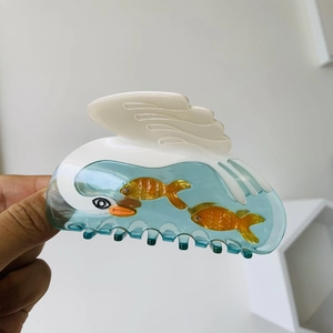 Acetate swan hair claw clip with floating fish design and elegant vintage matte finish