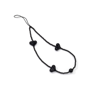 Detail of handmade black beaded phone strap with acrylic heart beads on white background