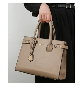 Detail of khaki leather tote bag with gold studs and Fashion & Bags printed text