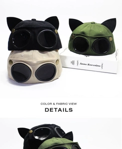 Detail showing pilot goggles and cat ear accents on a durable canvas baseball cap
