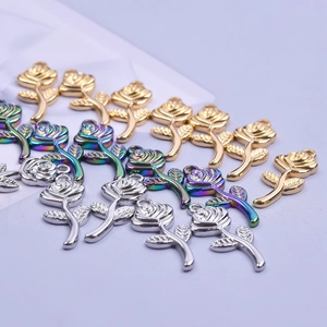 Detailed macro view of colorful rose charms in gold, silver and iridescent finishes
