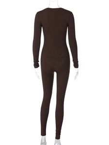Close-up of dark brown ribbed knit fabric texture on a slim fit long sleeve jumpsuit