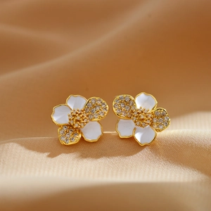 Elegant gold plated flower earrings with white enamel and sparkling rhinestones