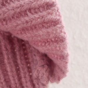 Pink V-neck short sleeve knit top with soft ribbed texture and single button detail