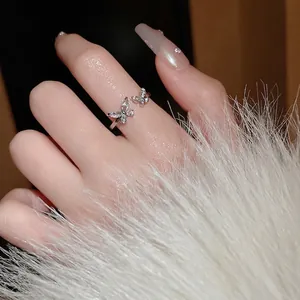 Silver open butterfly ring with shimmering cubic zirconia, elegantly worn on a hand