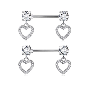 Detail of pink heart-shaped nipple rings with sparkling cubic zirconia on silver steel