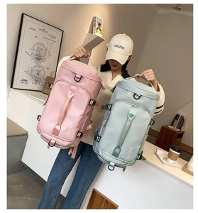 Detail of pink and mint travel bags with adjustable side straps and waterproof texture