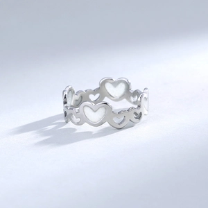 Detailed close-up of 304 stainless steel glowing heart ring with white inlay detail