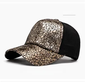 Detailed view of golden geometric crackle texture on baseball cap with black mesh