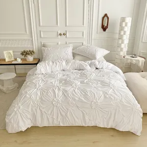 White pinched pleat bedding set including duvet cover and pillowcases in a bedroom