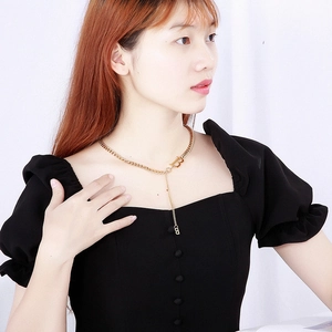 Fashionable stainless steel gold chain necklace featuring a B letter pendant on model
