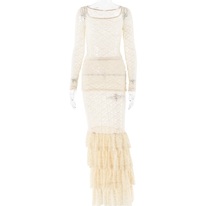 Close-up of beige lace fabric texture and ruffle details on this long-sleeve dress