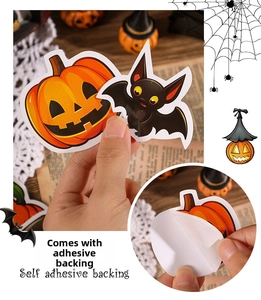 Detail showing self-adhesive backing of Halloween stickers with pumpkin and bat designs