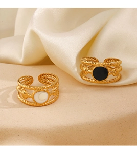 Detailed close-up of gold plated stainless steel ring with twisted rope texture
