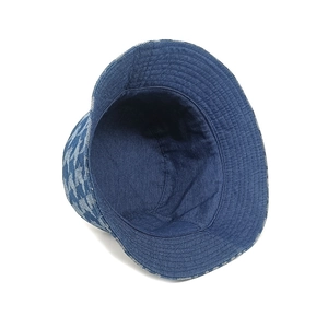 Detail of blue houndstooth pattern and reinforced stitching on a denim bucket hat