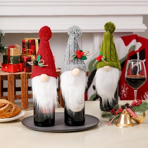 Three Christmas gnome wine bottle covers in red, grey, and green knitted fabric decoration