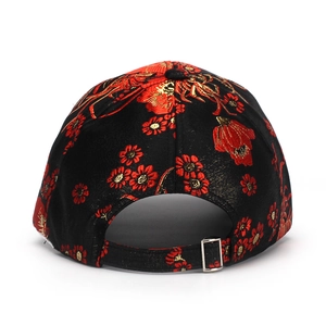 Detail of floral embroidery on black silk baseball cap with adjustable metal buckle back