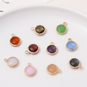 Nine colorful 10mm round crystal birthstone charms with gold metal frames for DIY jewelry