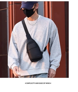 Detail of waterproof black men's chest bag with adjustable strap and matte finish