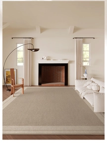 Detailed texture of a light beige woven rug on wooden floor in a cozy living room scene