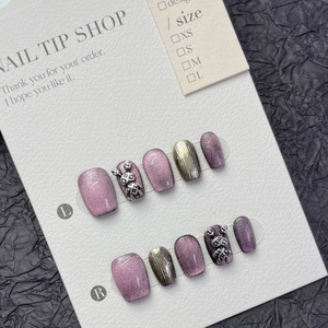 Detail of purple cat-eye press-on nails with 3D silver rabbit and metallic textures