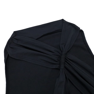 Dettaglio del top nero con scollo a V che mostra il nodo sulla spalla e le ruches