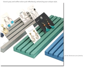 Close-up of angled jewelry display boards with slots for earrings and necklace cards