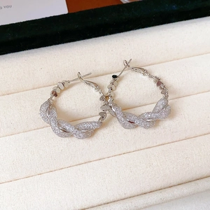 Silver twisted woven hoop earrings with zircon detail presented in a jewelry box