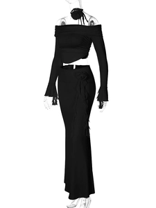 Detail of black two-piece set with long sleeve crop top and skirt featuring floral accents