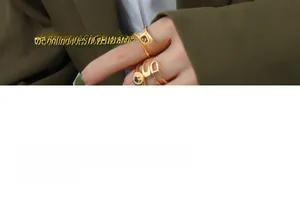 Detailed macro view of vintage gold-plated rings with hollow letters and heart relief