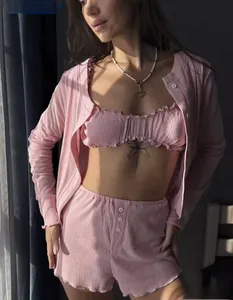 Detailed view of pink knitted three-piece loungewear with cardigan and buttoned shorts