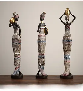 Close-up of African tribal statues with golden neck rings and geometric patterns