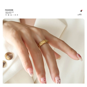Detailed relief of sun, moon, and star patterns on a vintage gold celestial ring