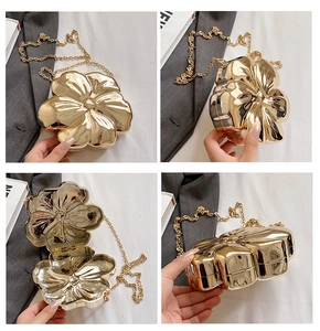 Detailed views of a gold flower-shaped hard shell evening clutch with chain strap