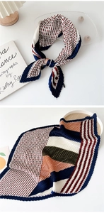 Detail of pleated silk scarf showing geometric diamond patterns and striped color block