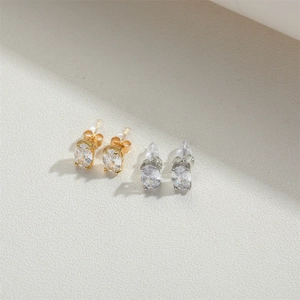 Classic gold and silver oval-cut stud earring set with sparkling cubic zirconia stones