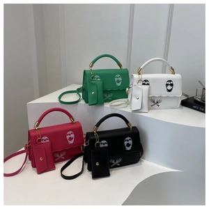 Detail view of four skull print crossbody bags with matching coin purses and metal handles