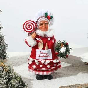 Detail of female chef Christmas doll with red plaid apron holding a festive lollipop