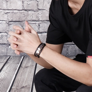 Men's punk braided black leather bracelet featuring a silver metal skull ornament