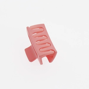 Detail shot of mini pink matte square hair claw clip with hollow design and smooth texture