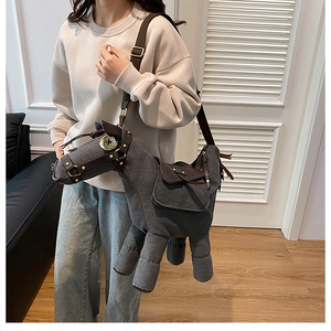 Detailed view of the large horse-shaped canvas crossbody bag worn by a model