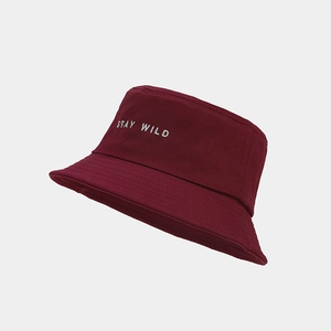 Détail de la broderie blanche « STAY WILD » sur un bob en toile bordeaux durable