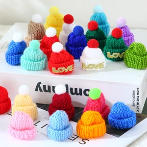 Mini knitted Christmas hats with colorful pom-poms and gold LOVE charms for DIY gifts