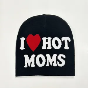 Detailed knit texture of a black beanie featuring a white I HOT MOMS jacquard design