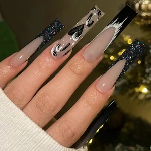 Long gothic press-on nails with black glitter French tips and silver bat patterns